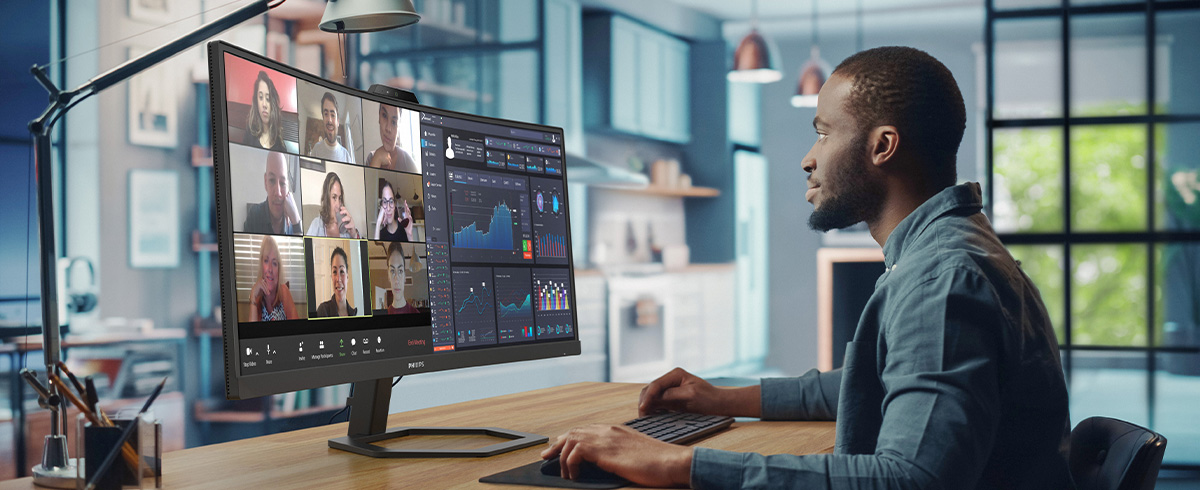 A person is working with Philips video conference monitor
